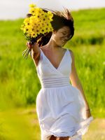 Girl-With-Yellow-Flowers-In-Field