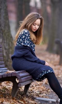 Beautiful-Girl-Sitting-On-Bench-In-Autumn