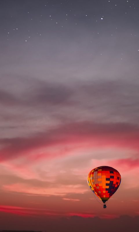 flying multicolored hot air balloon wallpaper