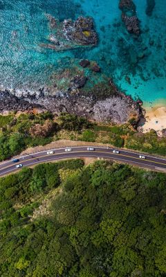 aerial view of road near body of water during dayt... wallpaper