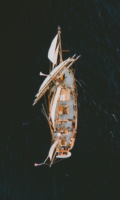 aerial photography of brown galleon ship on body o... wallpaper