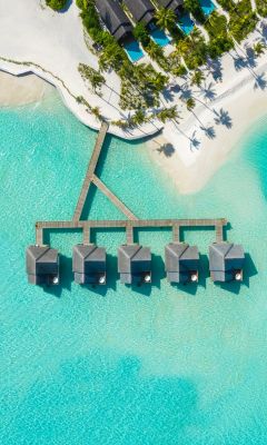 brown huts on body of water in aerial photography wallpaper