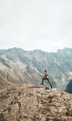 person standing on mountain scenery wallpaper